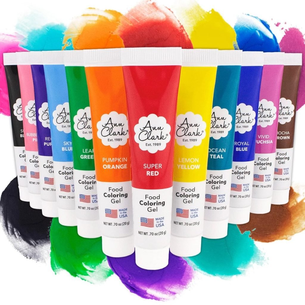 Various tubes of Ann Clark food coloring gel in different colors, including green, red, yellow, and purple, arranged in a row.