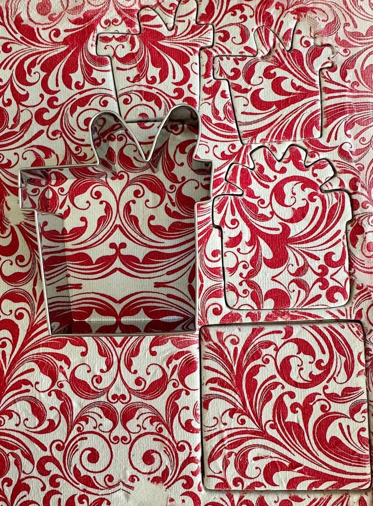 Red and white patterned cookie cutters on similarly patterned fabric.