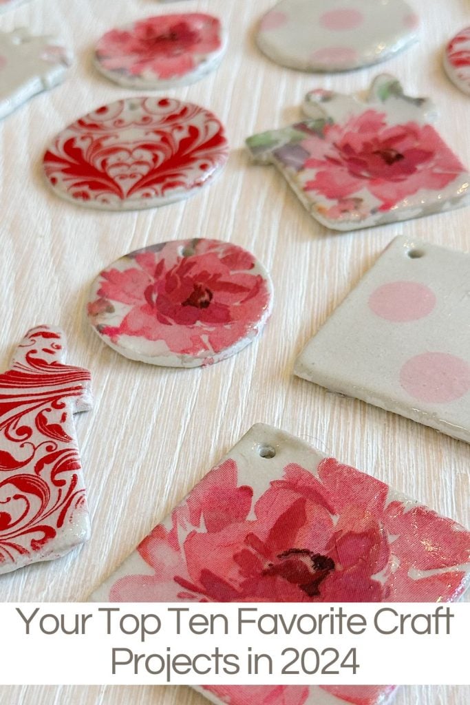 Assorted floral and patterned ceramic crafts on a light surface.