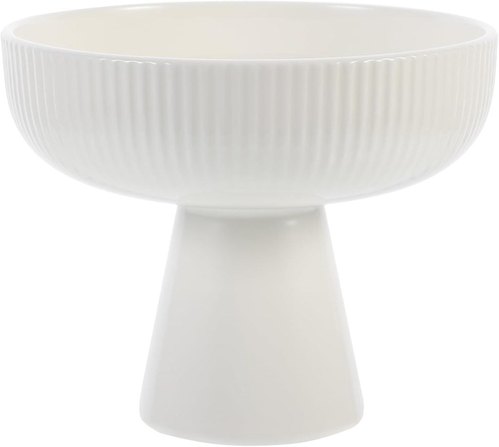 A white ceramic bowl with a ribbed design on a conical base, shown against a plain background.