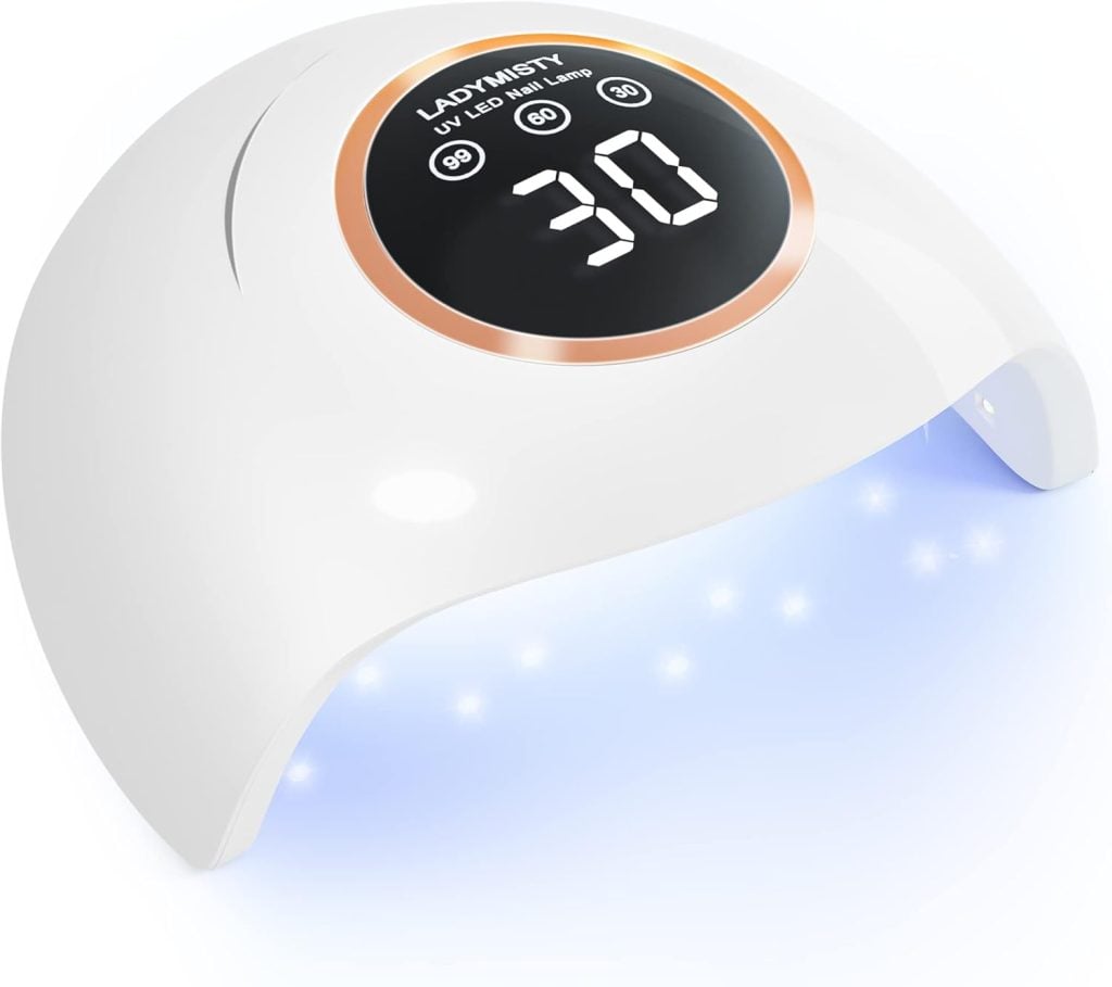 The white UV LED nail lamp, perfect for drying air dry clay creations, features a digital display showing "30" and the brand name "LADYMISTY" on top. A gentle blue light glows from within, ensuring efficient curing.