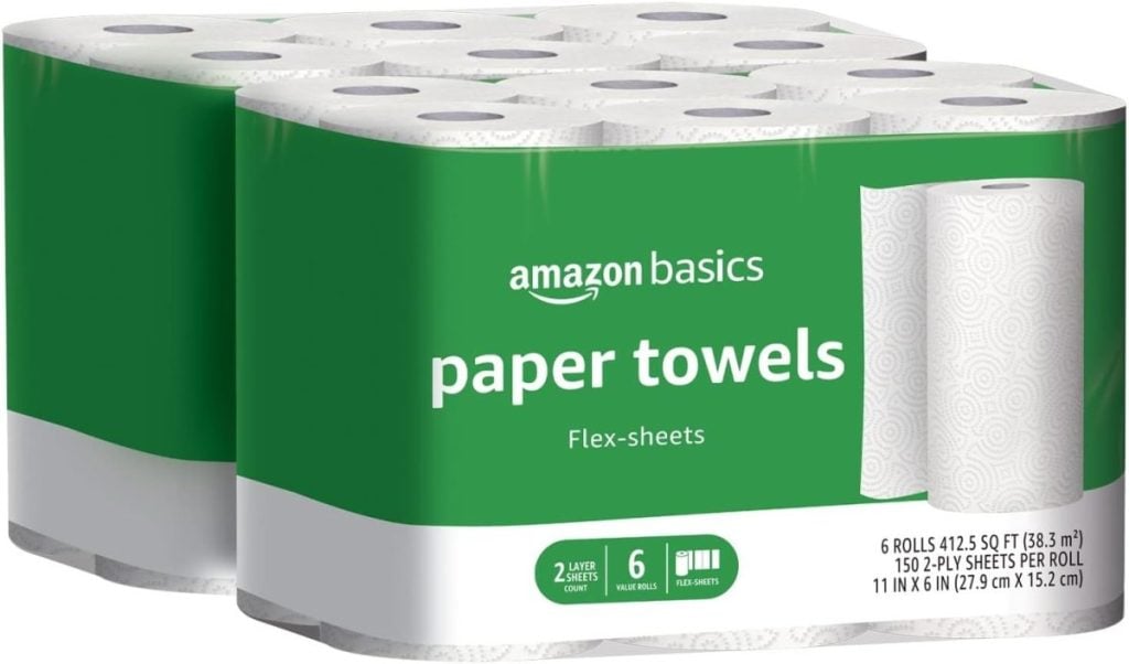 Two packs of Amazon Basics paper towels are shown, each containing six rolls with 150 2-ply sheets per roll. Packaging includes the text "Flex-sheets.