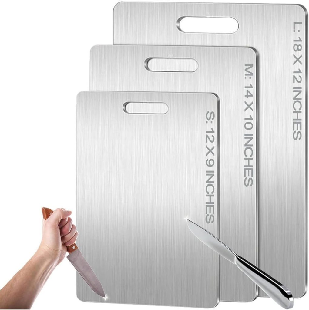 Three stainless steel cutting boards in small, medium, and large sizes, each labeled with dimensions, make essential kitchen items. Two hands holding knives are seen in the foreground.