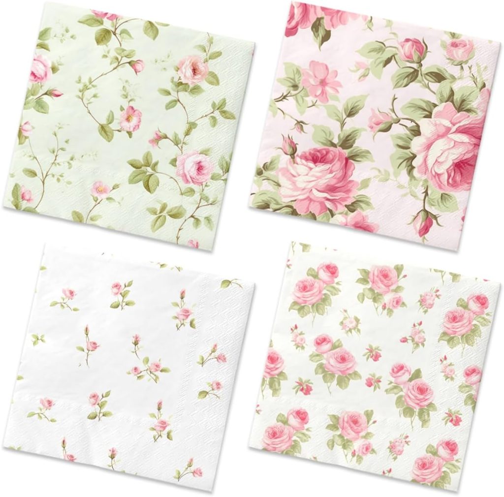 Four floral-patterned napkins featuring various pink roses and green leaves on white and light green backgrounds.