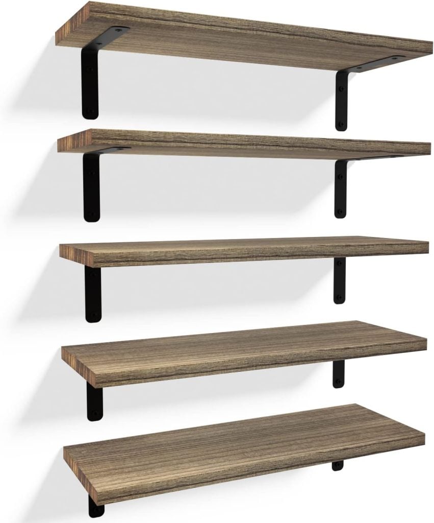 Five wooden shelves with black metal brackets, ideal for open kitchen shelving, mounted on a white wall.