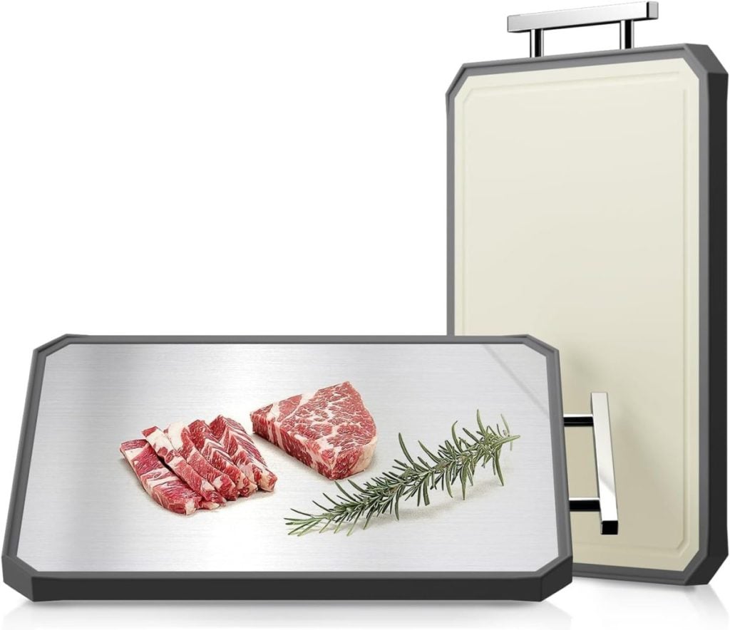 Two defrosting trays, essential kitchen items, feature one with raw meat and a sprig of rosemary. A second tray stands upright in the background with a handle, ready for use.