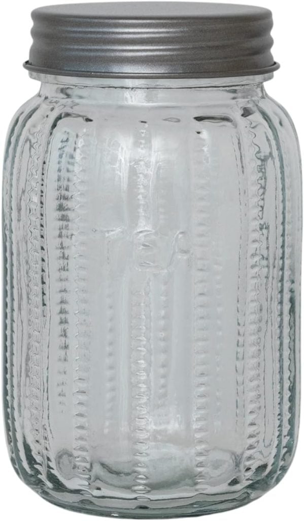 A clear glass jar with a metal screw-on lid and textured sides.