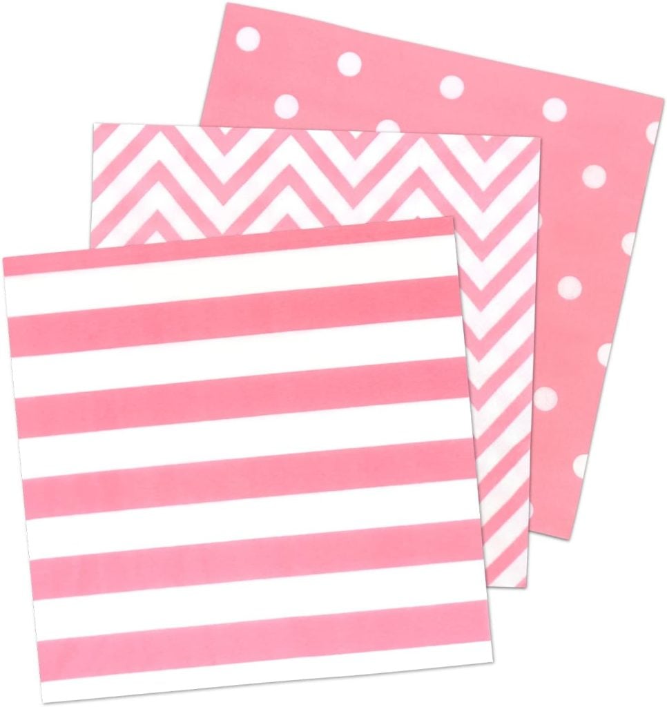 Three pink-patterned napkins: one with polka dots, one with chevrons, and one with stripes.