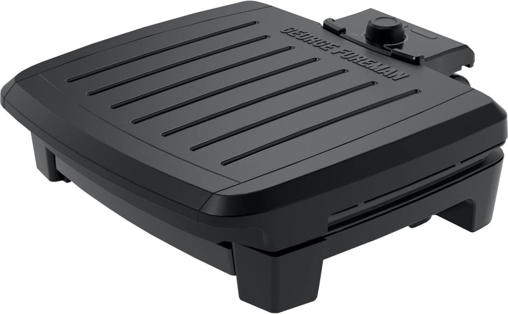 Black George Foreman electric grill with a ridged lid and temperature dial, perfect for sizzling up your favorite dishes, like crispy brown sugar bacon.