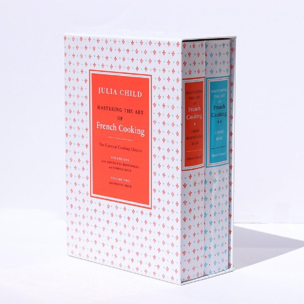 Two-volume book set, "Mastering the Art of French Cooking" by Julia Child, perfect for display on open kitchen shelving, in a decorative slipcase.