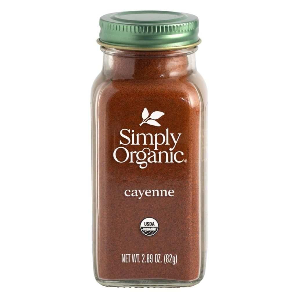 A glass jar of Simply Organic cayenne pepper with a green lid pairs perfectly with your brown sugar bacon recipes. Net weight: 2.89 oz (82g). USDA Organic label on the front.