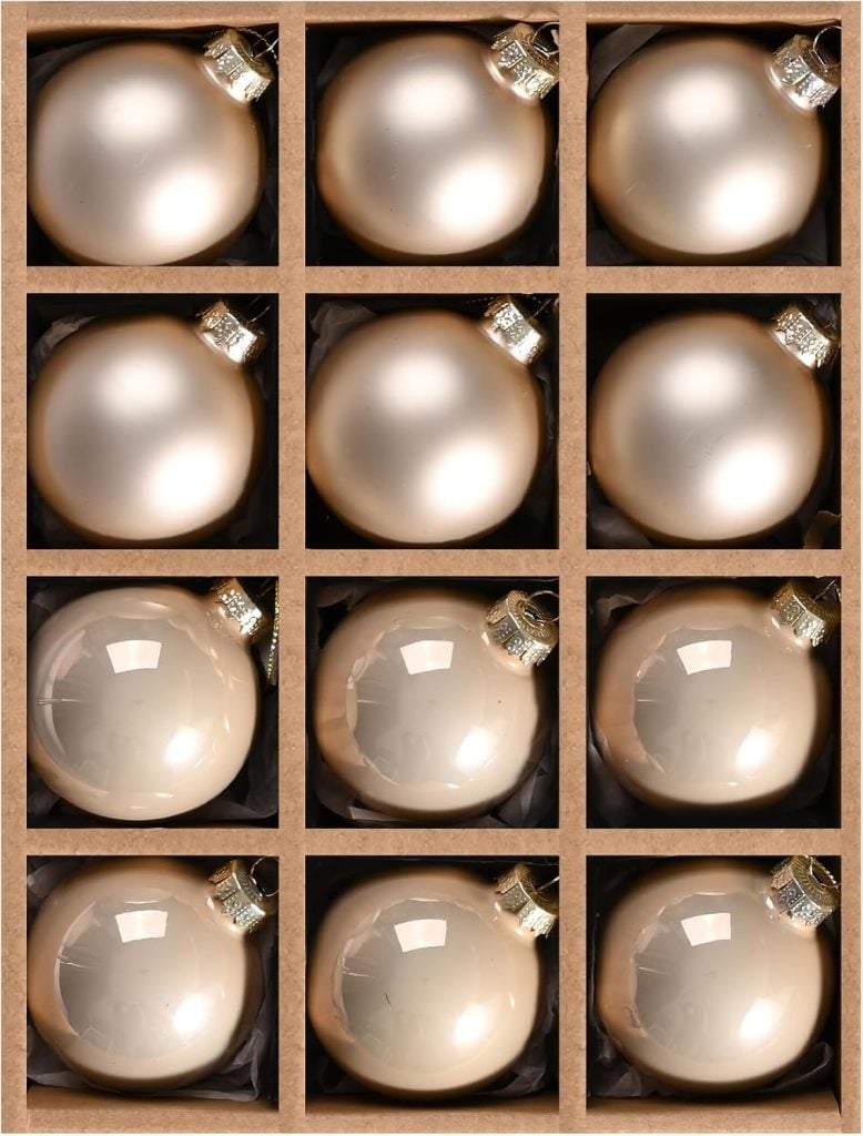 A grid of twelve beige Christmas ornaments sits in a cardboard box, each nestled in its own compartment, ready to add a touch of festive charm to your kitchen decor.