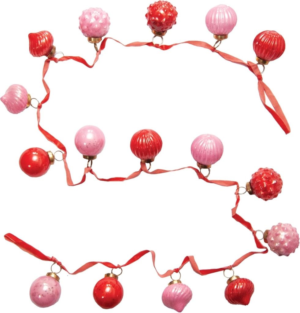 A garland with alternating pink and red ornament balls attached to a red ribbon, arranged in a loose zigzag pattern—a charming touch when paired with a Heart Pillow for festive decor.