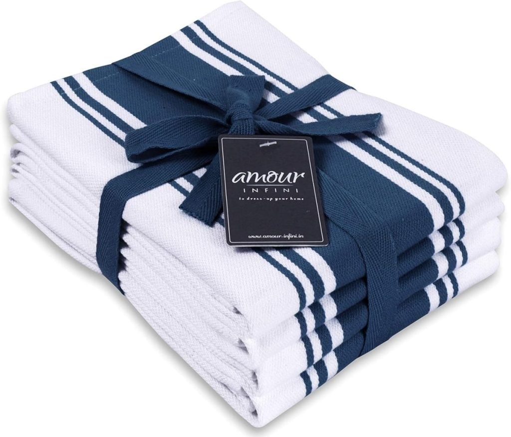 A stack of white and navy blue striped kitchen towels, essential kitchen items, is folded neatly with a navy blue ribbon and a tag labeled "amour infini.