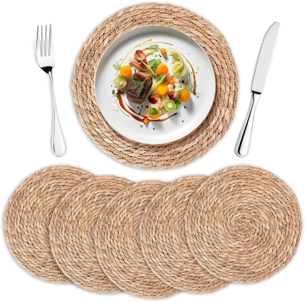 A set of five round woven placemats, with one displayed under a plate of food alongside a fork and knife&mdash;perfect for complementing your handmade air dry clay tableware.
