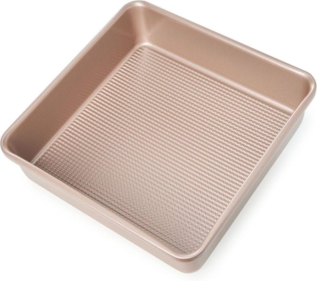 A square, nonstick baking pan with a textured base and metallic finish, viewed from above at an angle&mdash;perfect for preparing treats or arranging your Valentine's Day Charcuterie Board.