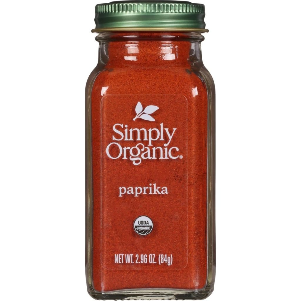 A glass jar of Simply Organic paprika, 2.96 oz (84g), with a green metal lid and USDA organic label, perfect for adding depth to your brown sugar bacon recipes.