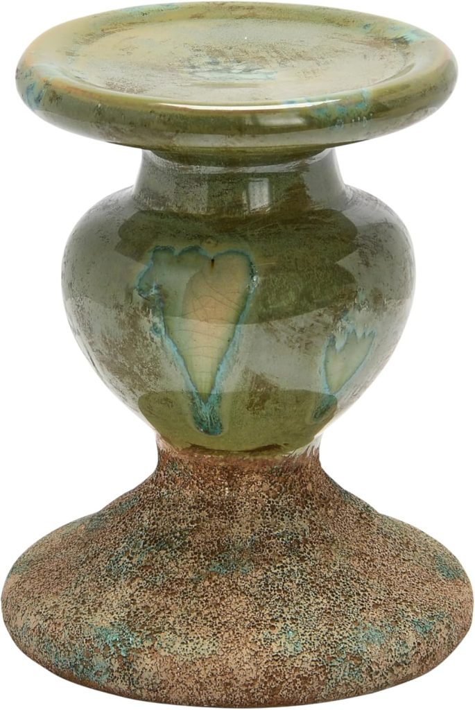A ceramic pedestal with a glazed green and brown finish in a winter color palette, featuring a wide flat top and a rounded central section.