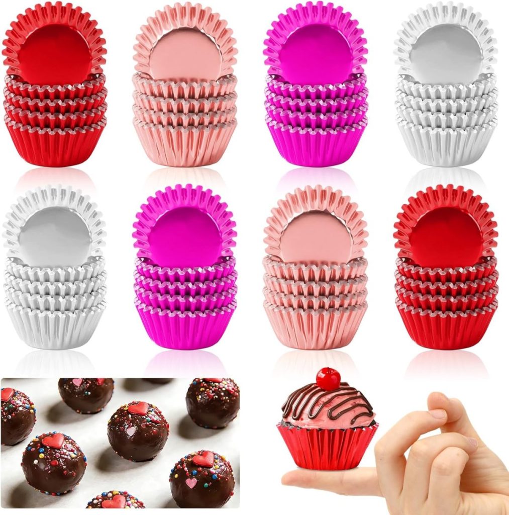 Colorful metallic cupcake and candy wrappers in red, pink, silver, and purple, shown in stacks and with Valentine's cupcakes and other decorated treats displayed in the wrappers.