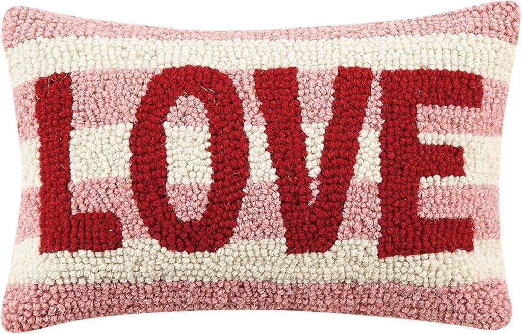 Rectangular heart pillow with pink and white horizontal stripes, featuring the word "LOVE" in large red letters across the front.
