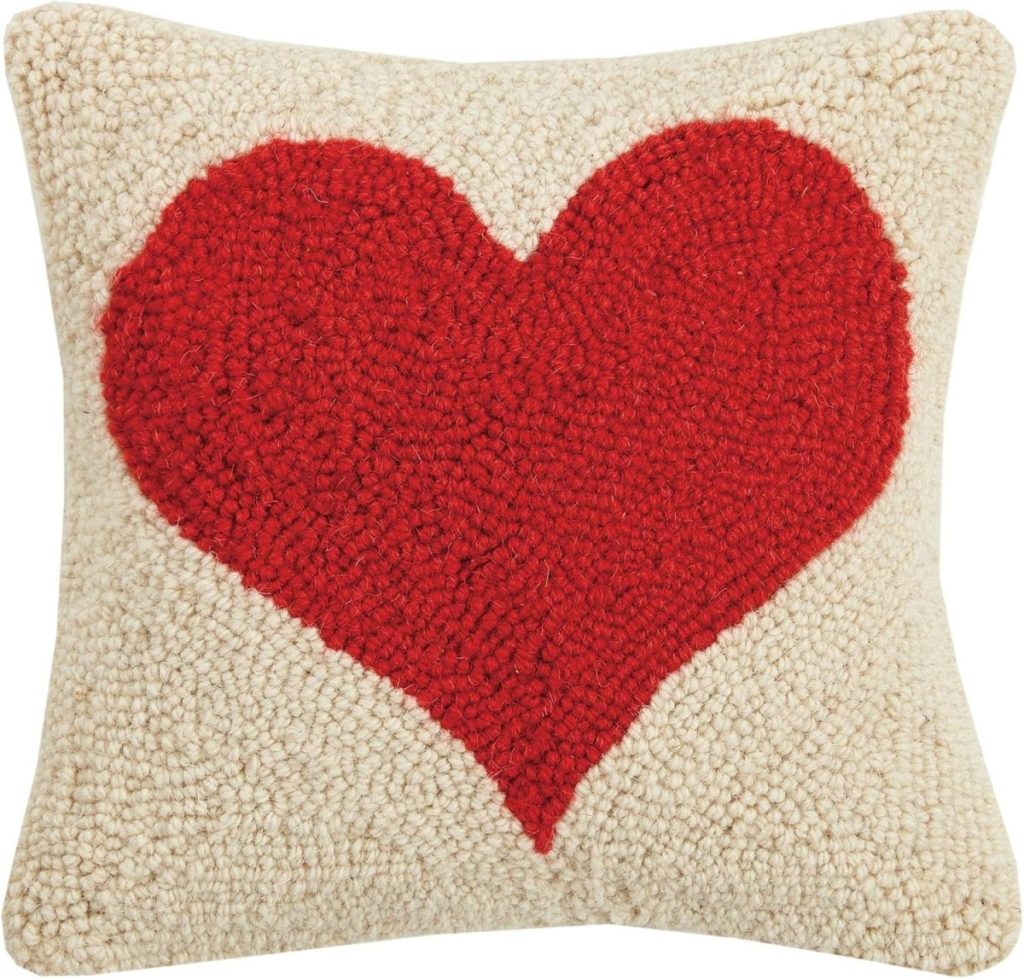 Square cream throw pillow with a textured red heart design in the center, perfect for gifting alongside Valentine's Day Cards.