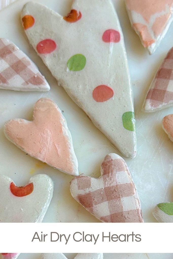 Assorted air-dry clay hearts with pastel colors and patterns on a white surface.