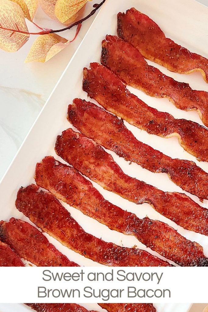 Slices of brown sugar bacon arranged on a white platter with decorative leaves in the corner.