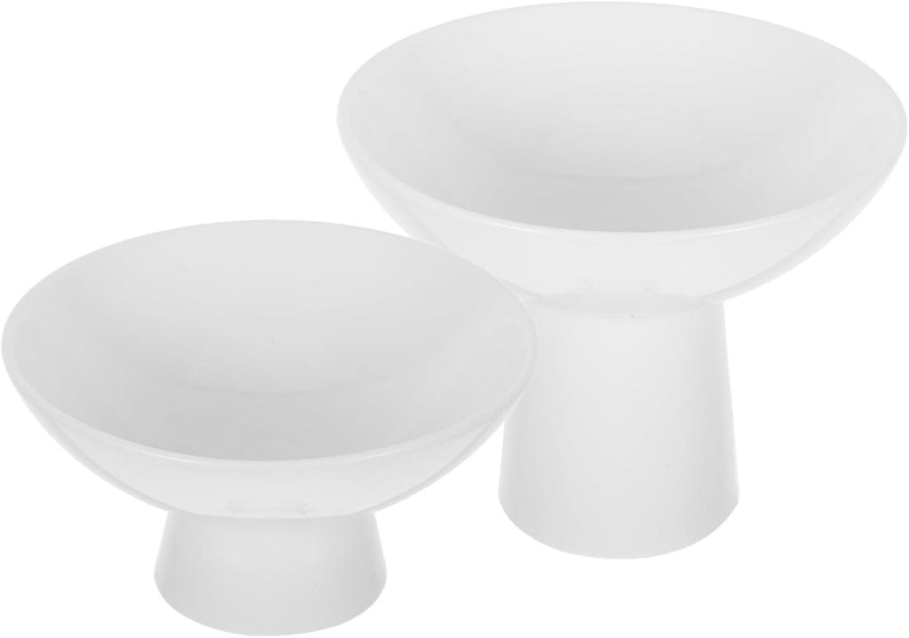 Two white ceramic bowls with wide openings and short pedestal bases, placed side by side on a plain background—perfect for your next Valentine DIY project.
