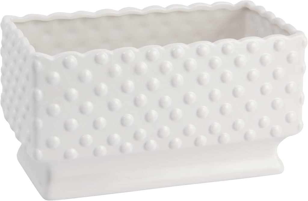 Rectangular white ceramic planter with a raised dotted pattern and scalloped edges, placed on a matching base—perfect as dining room table decor.