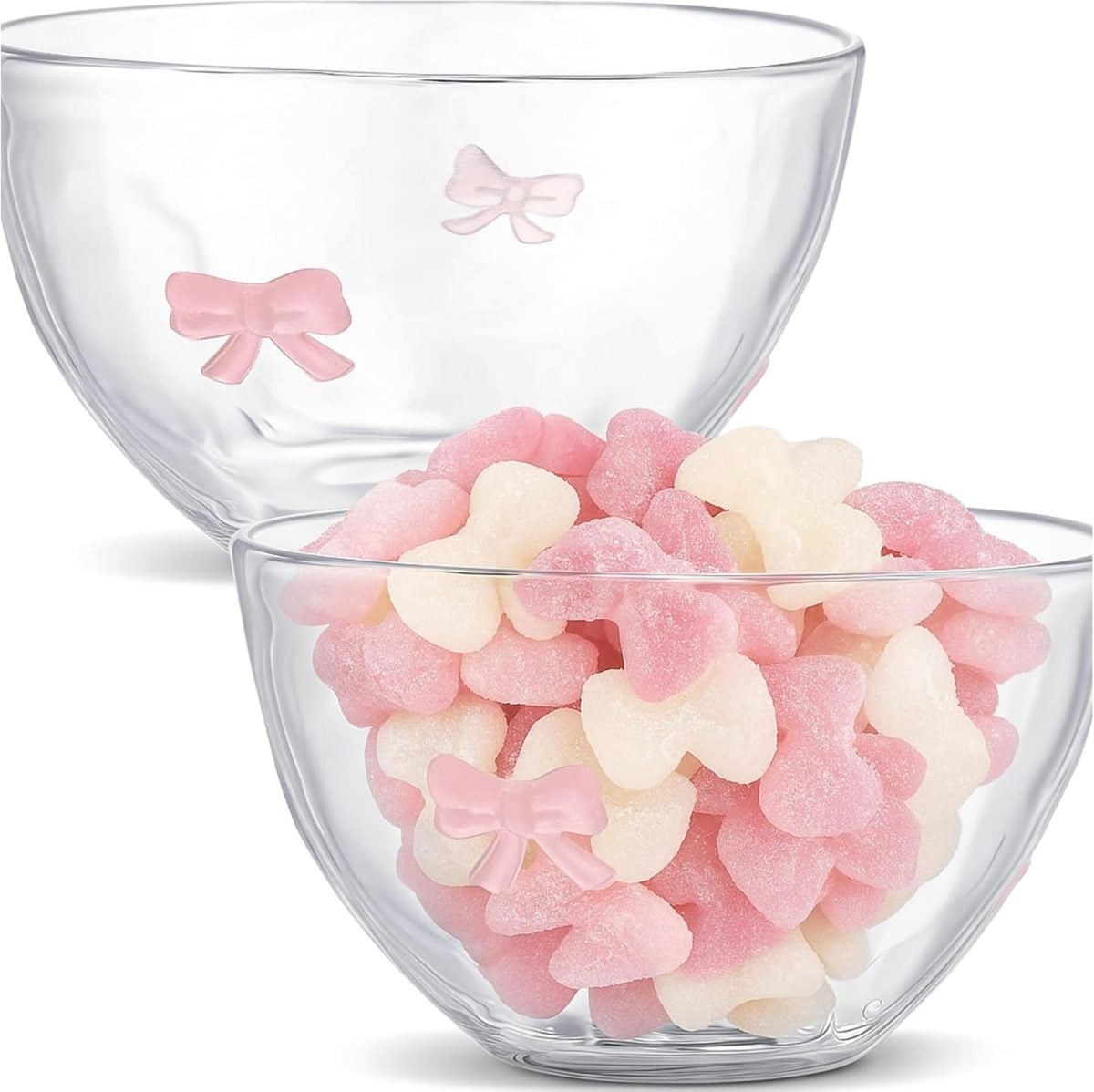 Two clear glass bowls, each decorated with small pink bow designs, make a charming Valentine DIY display&mdash;one is filled with pink and white bow-shaped gummy candies.