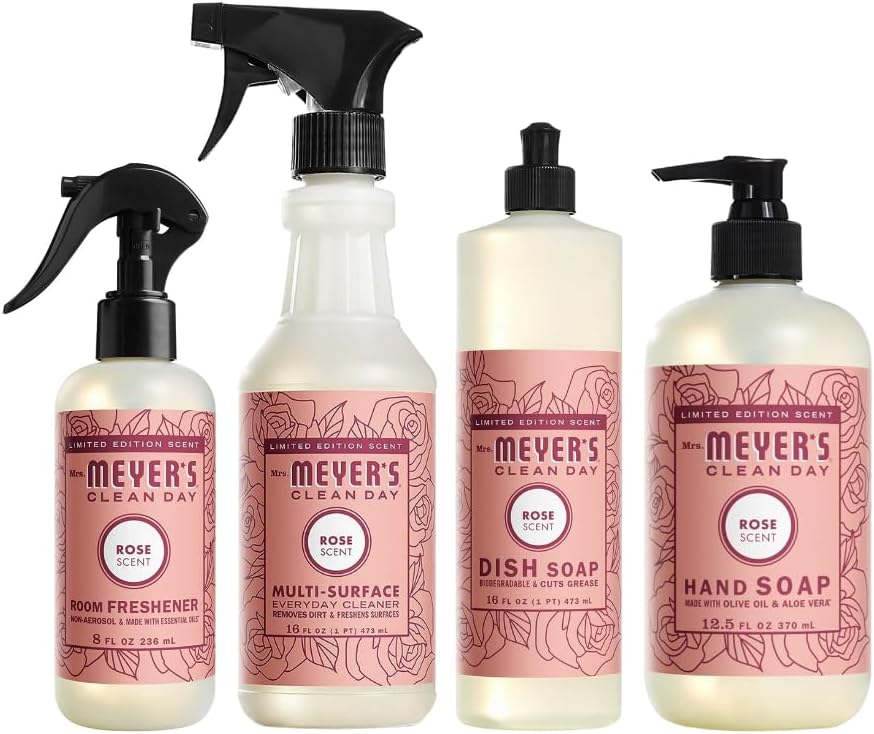 Four Mrs. Meyer's Clean Day rose scent products&mdash;room freshener, multi-surface cleaner, dish soap, and hand soap&mdash;arranged side by side in clear bottles with pink labels make an easy DIY project for a beautifully scented home.