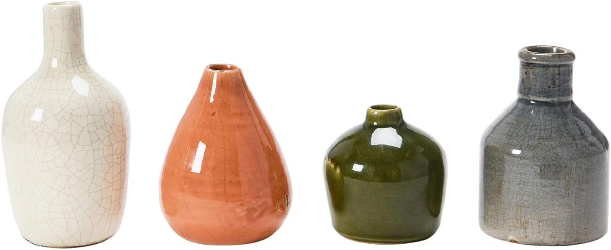 Four small ceramic vases in different shapes and colors—white, orange, green, and gray—arranged in a row on a white background, perfect for adding a fresh touch to your spring decor.