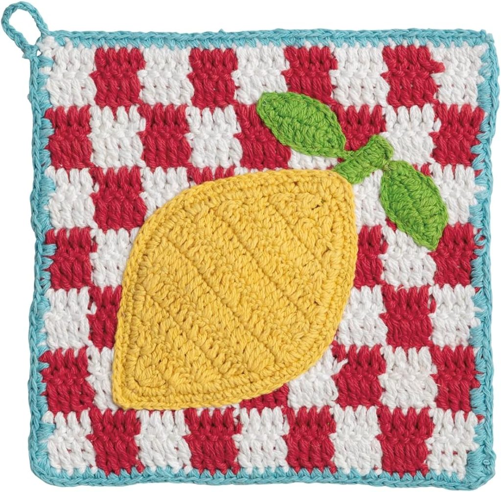 A crocheted potholder with a red and white checkered pattern, blue border, and a yellow lemon with green leaves stitched on top&mdash;perfect for adding cheerful lemon decor to your kitchen.