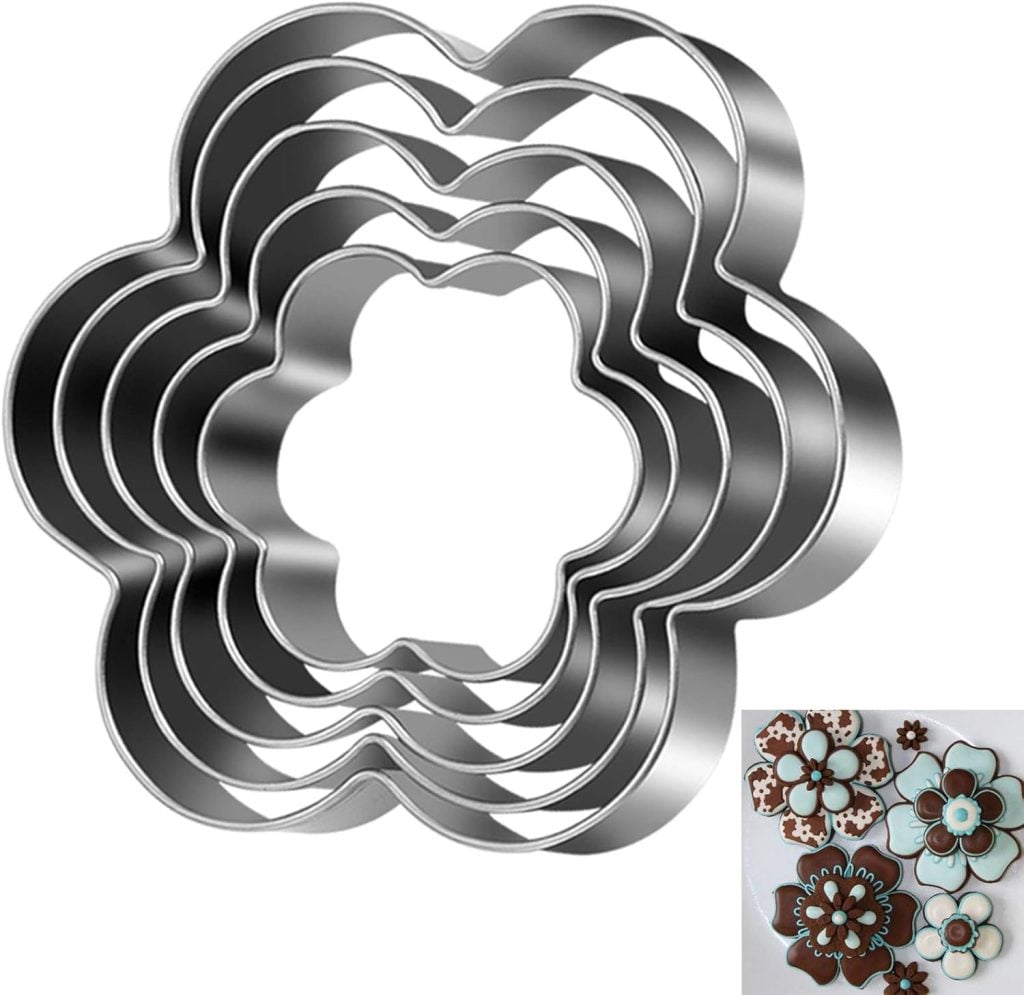 A set of six nested, metal flower-shaped cookie cutters—perfect for making beautiful flower cookies—includes decorated flower cookies shown in the bottom right corner.