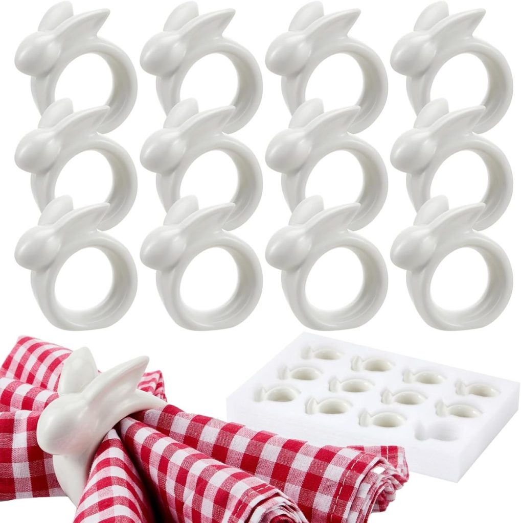 Twelve white ceramic napkin rings shaped like rabbits, perfect for Easter decor, with one holding red and white checkered napkins, displayed next to a storage box.