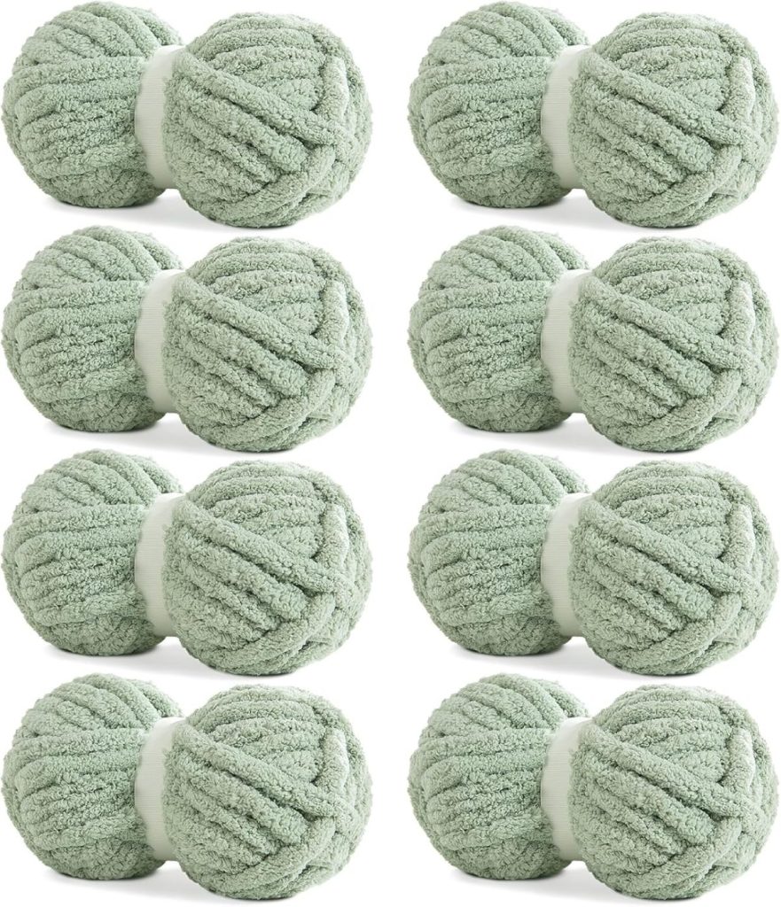 Eight skeins of soft, light green yarn arranged in two rows of four evoke the cozy, inviting look of Pottery Barn pillow covers against a crisp white background.