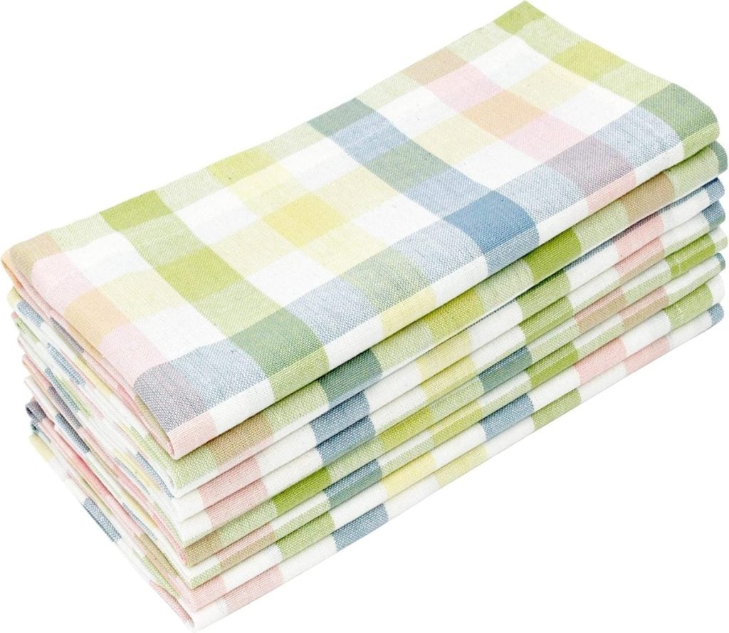 A stack of folded plaid cloth napkins in pastel colors&mdash;perfect for serving your Best Deviled Eggs Recipe&mdash;adds a charming touch to any table on a crisp white background.