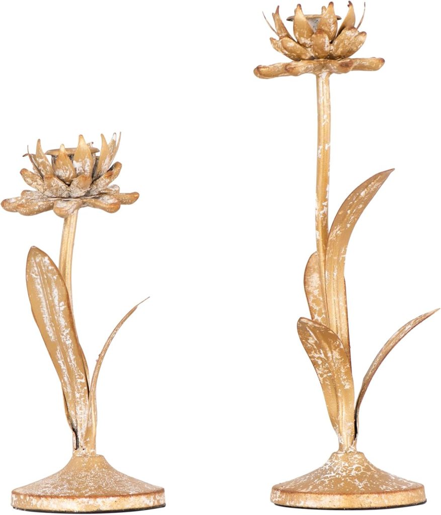 Two gold-toned metal candle holders shaped like flowers with stems and leaves, each standing on a round base. One holder is taller than the other, perfect for displaying candles or even small Easter eggs in a festive spring display.