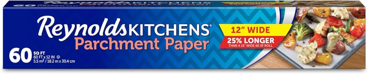 Box of Reynolds Kitchens Parchment Paper, 60 square feet, with a festive touch for your Easter egg decorating. Features 12-inch width and advertises 25% longer than standard size, displayed with an image of roasted vegetables on parchment.