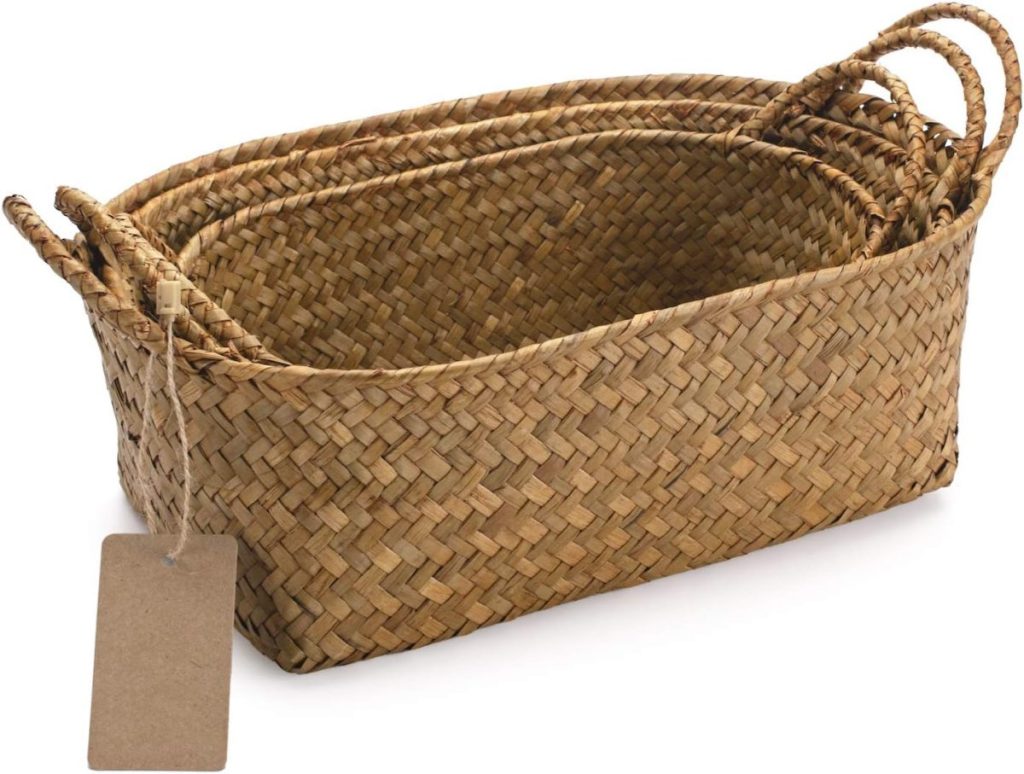 Three rectangular woven baskets of varying sizes are nested together, each with two handles and an attached blank tag—perfect for organizing your Airbnb in Waco with style and convenience.