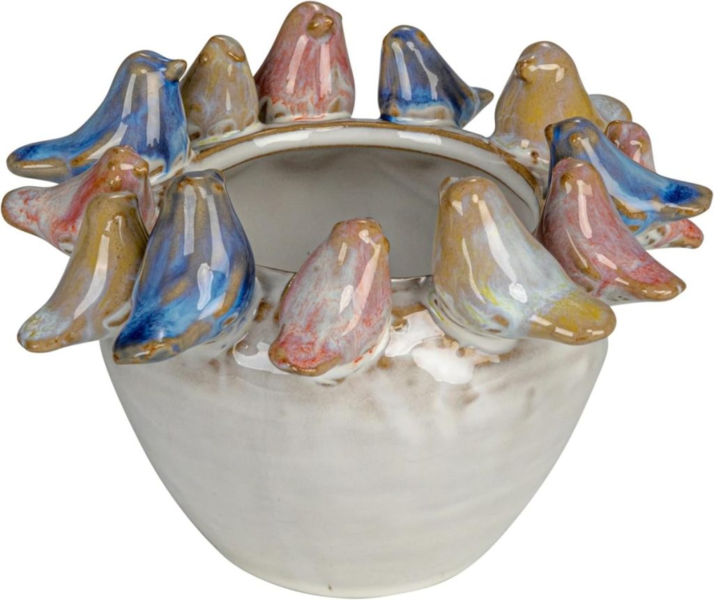 A round ceramic bowl with small, colorful bird figurines perched around its rim, perfect for displaying Easter eggs.