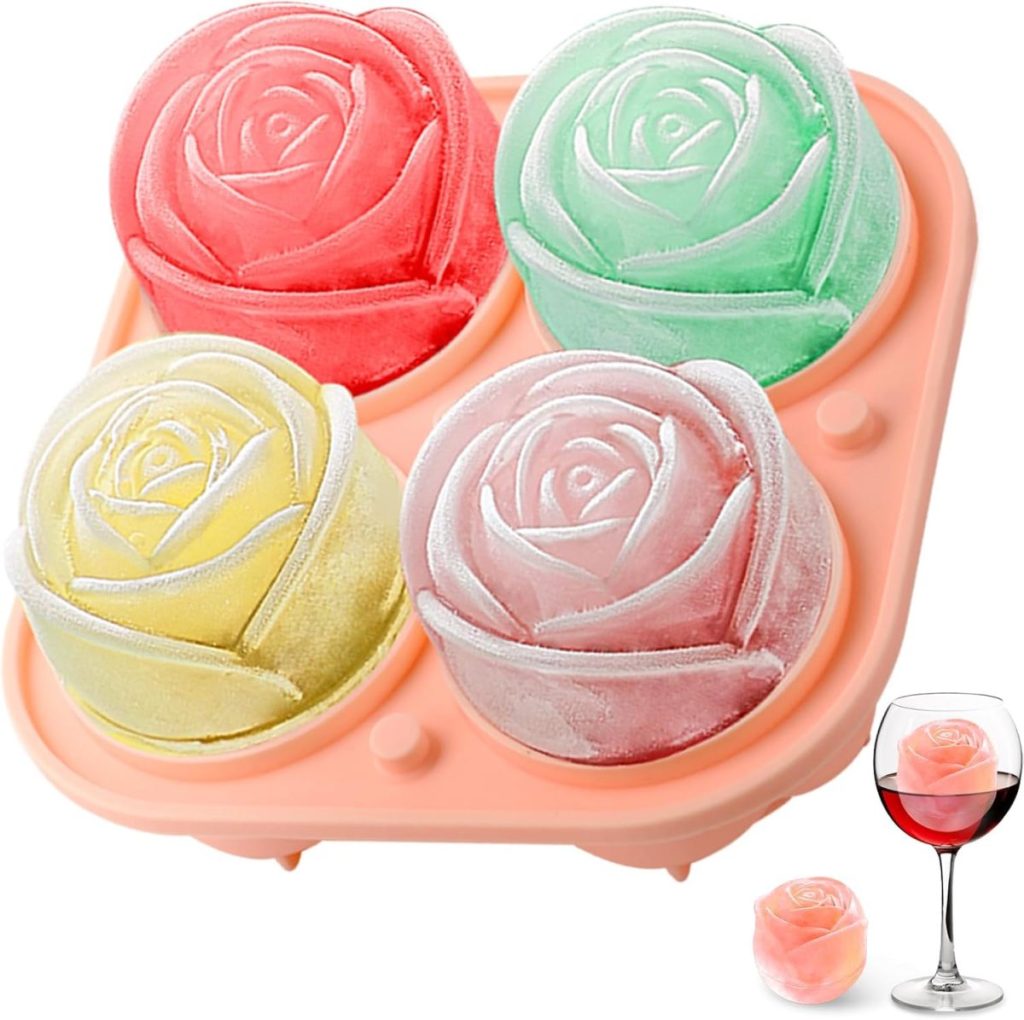A pink tray with four large rose-shaped ice molds in red, green, yellow, and pink, perfect for chilling a glass of lemon vodka that holds one lovely ice rose beside the tray.
