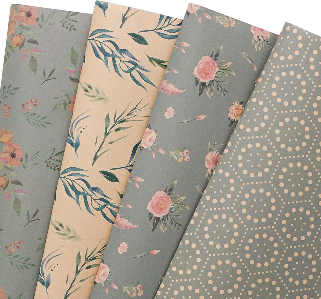 Four sheets of vintage wrapping paper laid out, each with a different design: floral, leafy, roses, and a dotted hexagonal pattern in muted colors.