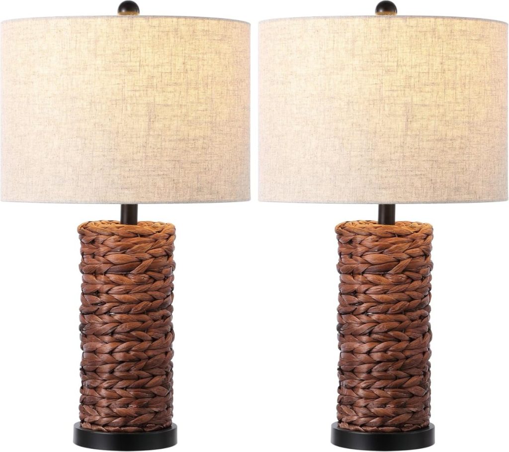 Two table lamps with woven brown bases and cylindrical beige fabric shades, perfect for adding warmth to your Airbnb in Waco, displayed side by side against a white background.