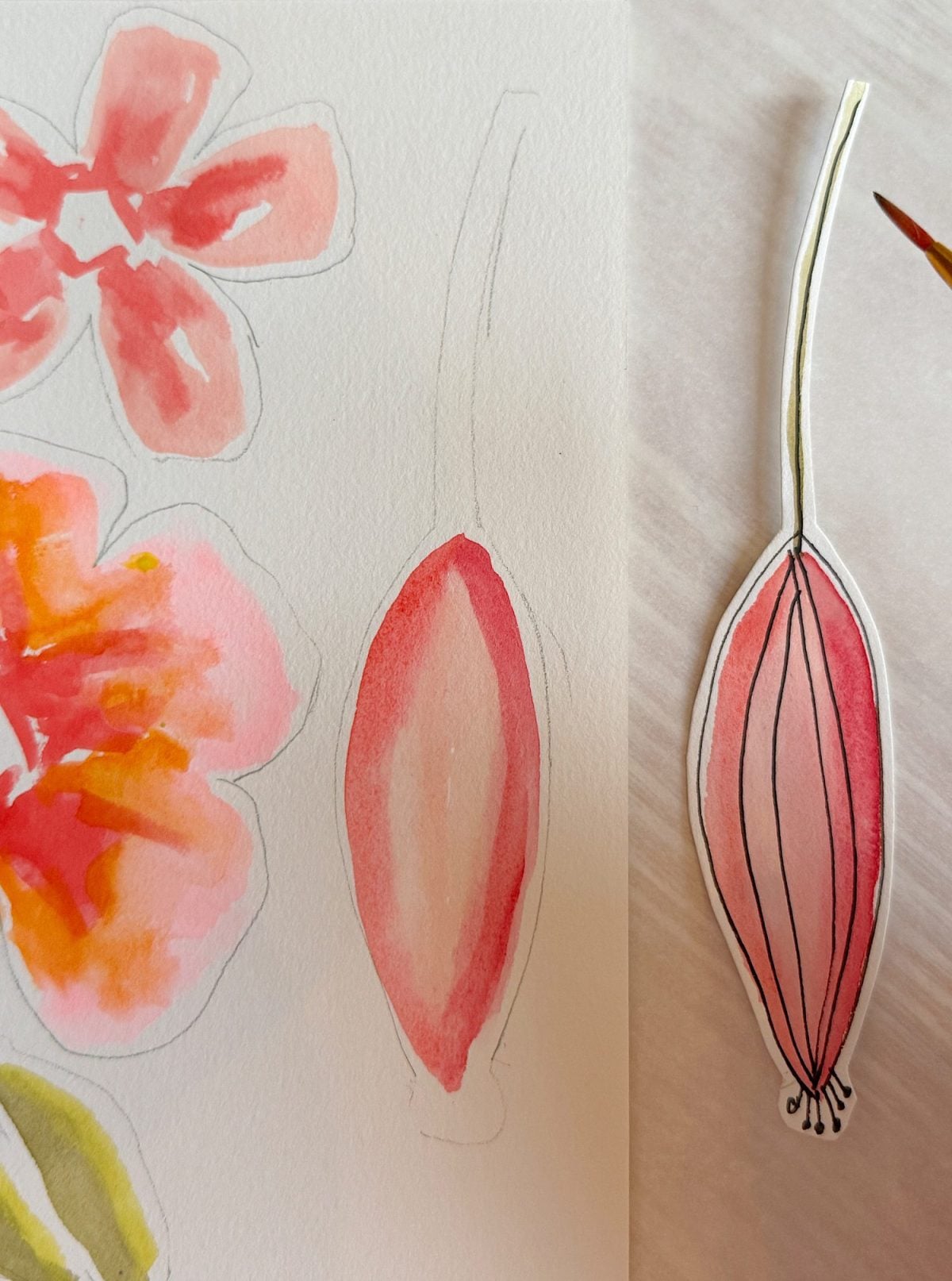 A watercolor sketch and an outlined cutout of a pink and red flower bud are placed side by side on a light surface.