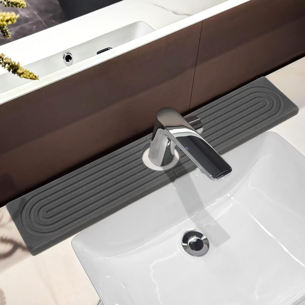 Modern bathroom sink with a rectangular gray silicone mat under the faucet, designed to catch water drips, set on a glossy countertop—perfect for homes with an open concept kitchen and seamless style throughout.