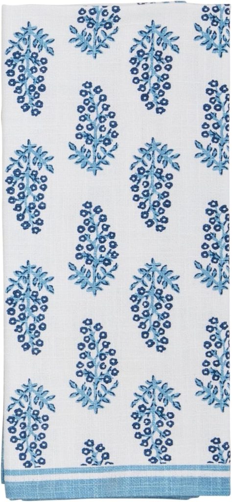 White cloth with a repeating blue floral pattern and a blue border along the bottom edge—perfect for summer decorating ideas.