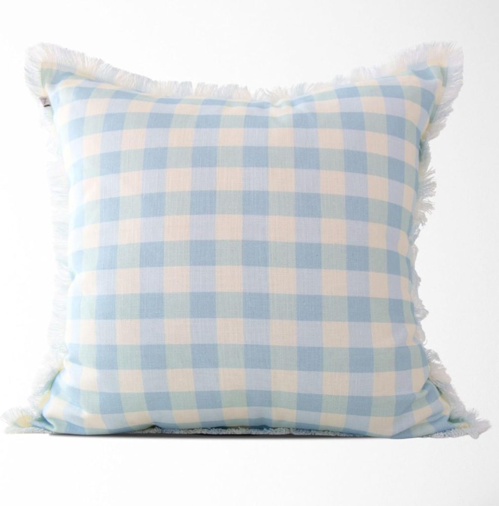 Square cushion with a blue and white gingham check pattern and fringe trim around the edges—perfect for adding a fresh touch to your Summer Decorating Ideas, set against a plain white background.