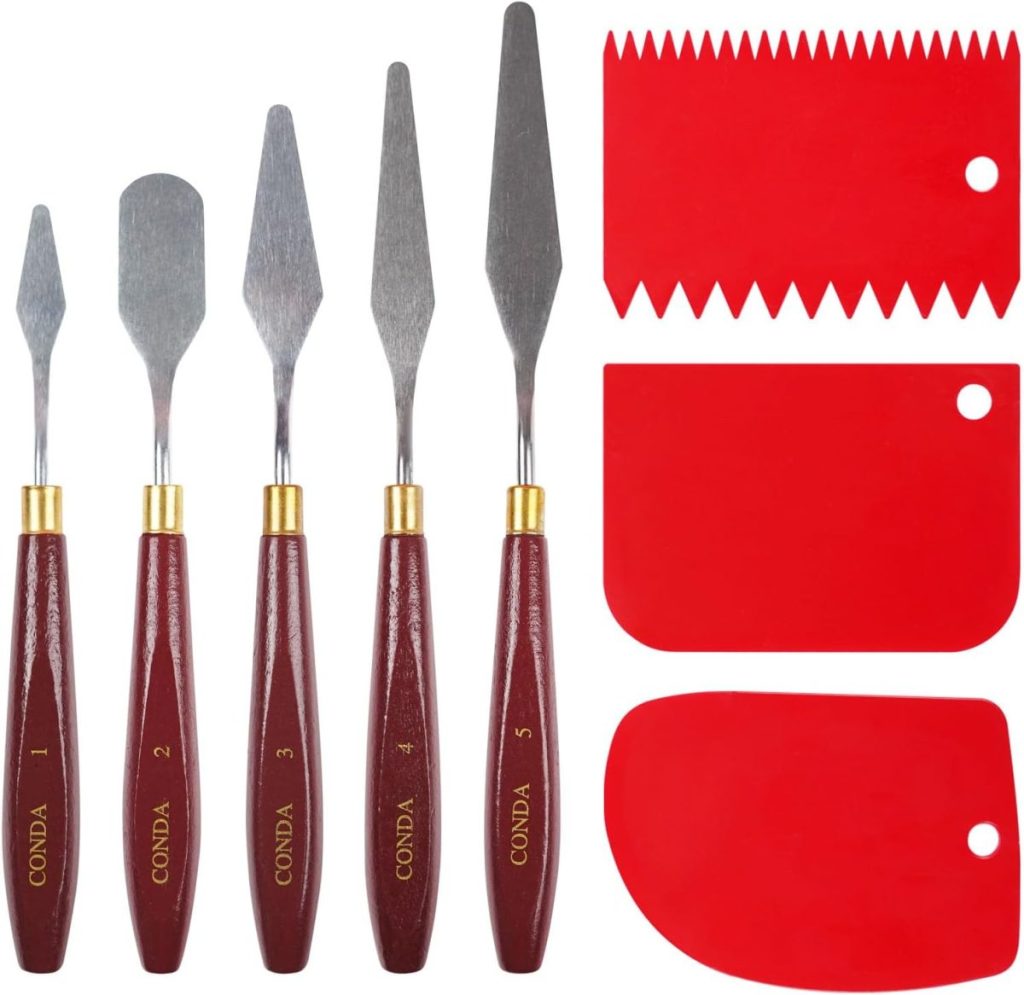 A set of five metal paint palette knives with wooden handles and three red plastic scrapers, each with different edge shapes—perfect for decorating a spring cake or your next creative project, featuring handy holes for easy hanging.