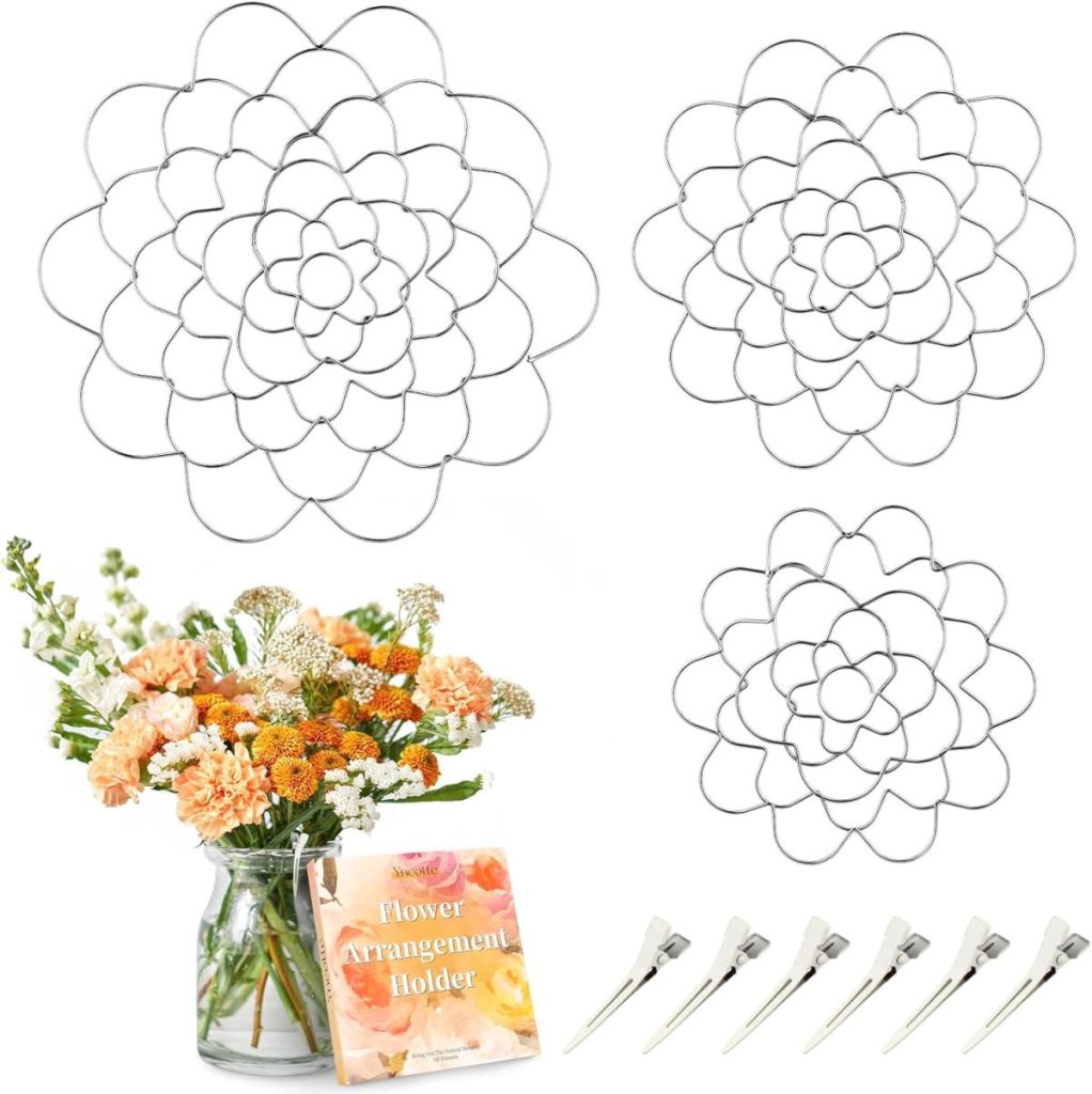 Three metal flower arrangement holders in different sizes, a glass jar filled with summer wedding flowers, a booklet, and six metal clips are displayed on a white background.